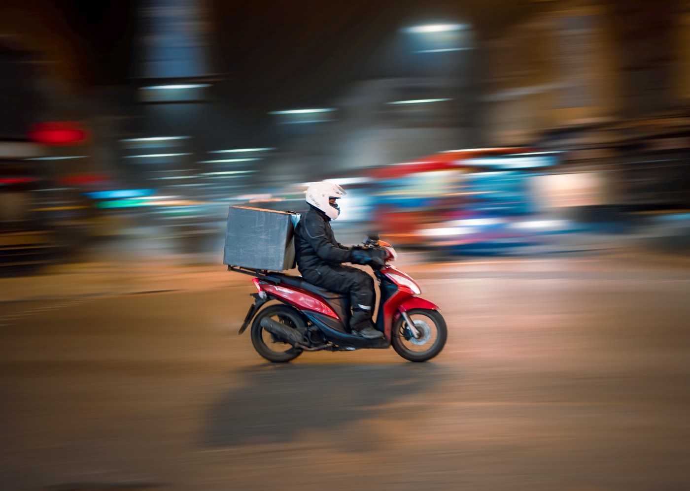 Image of a courier on a scooter